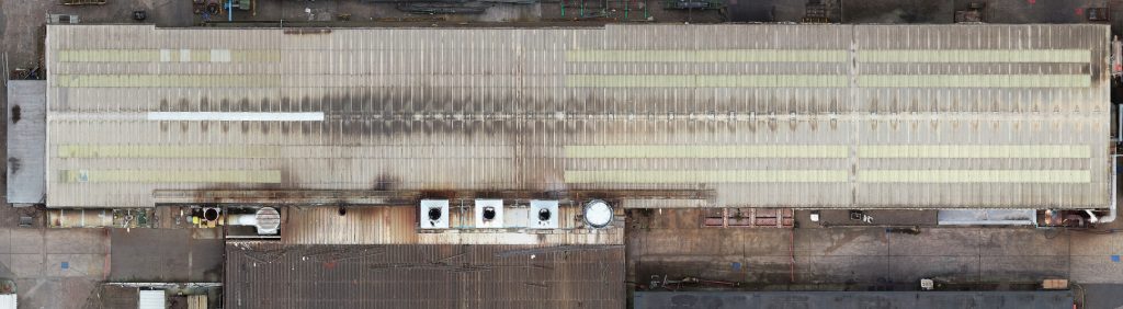 Showing an aerial view of a factory rood captured by drone.